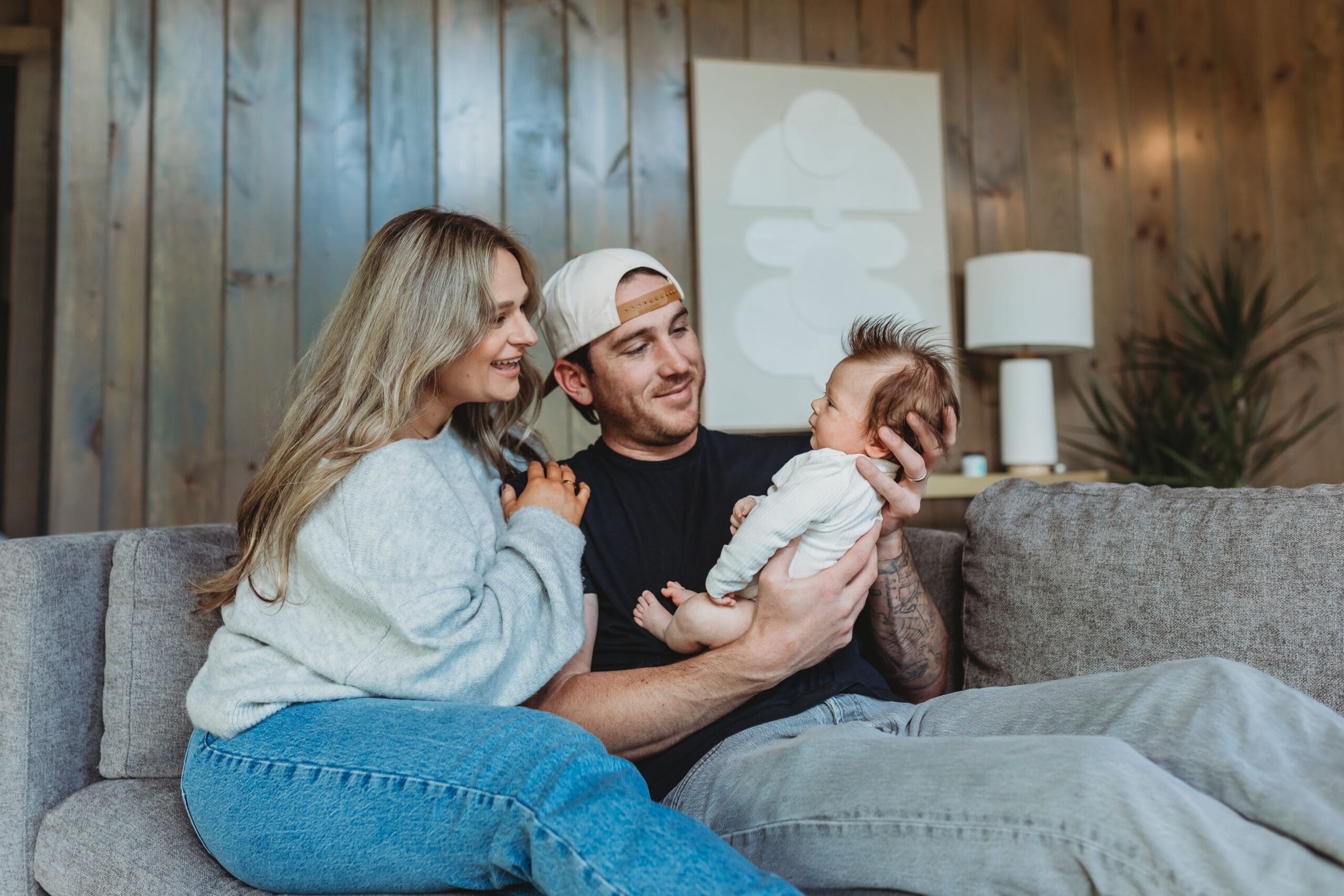 Lifestyle newborn session with awake 6 week old baby in parents arms